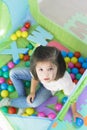 Little smiling girl playing lying in ball park. Close up, portrait Royalty Free Stock Photo