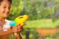 Little smiling happy boy shooting water gun Royalty Free Stock Photo