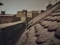 Little snow in city roof top