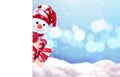 Little snowman in cap with gift on snow in the winter. Background with a funny snowman. Christmas card.