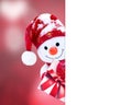 Little snowman in cap with gift on snow in the winter. Background with a funny snowman. Christmas card