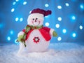 Little snowman toy on a New Year`s backgrou