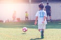 Little soccer boy training soccer football with small children for Kid football academy and sport school concept