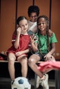 A little soccer player showing cellphone content to his friends Royalty Free Stock Photo