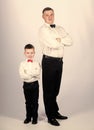 Little son following fathers example of noble man. Gentleman upbringing. Father and son formal clothes outfit. Grow up Royalty Free Stock Photo