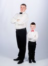 Little son following fathers example of noble man. Gentleman upbringing. Father and son formal clothes outfit. Grow up Royalty Free Stock Photo