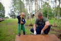 Little son helping his father with building work