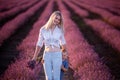 Little son hides behind mother. Young woman and boy walk through the rows of lavender purple field Royalty Free Stock Photo