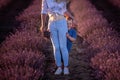 Little son hides behind mother. Young woman and boy walk through the rows of lavender purple field Royalty Free Stock Photo