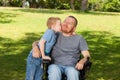 Little son kissing his disabled father. Royalty Free Stock Photo