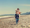 Little son with mother runs together at the sea coast Royalty Free Stock Photo