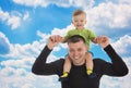 Little son sits on father shoulders