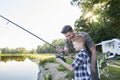 Little son taught by father how to do fishing Royalty Free Stock Photo