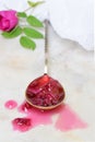 Little spoon with tea rose petal jam on light marble background. Copy space for text. Royalty Free Stock Photo