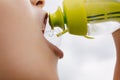 Little sports boy drinking water from filtering water bottle