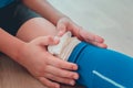 Little sporty football boy holding his knee wound from accident in soccer match