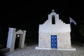 Little square with typical church with blue dome and Greek flag on Paros island, Cyclades, Greece Royalty Free Stock Photo