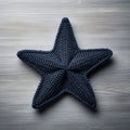 Little Star: Knitted Wool Starfish On Grey Wooden Background