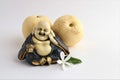 Little statue of laughing Buddha with pears