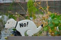 Little statue of a white dog saying no Royalty Free Stock Photo