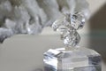 Beautiful little statuette of a transparent crystal, close up, space for text