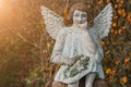 Little stone angel with a wreath in his hands concept of death, loss Royalty Free Stock Photo
