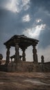 Little stone temple with dramatic mystic cloudy sky in hampi india