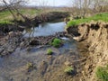 Little stream with little waterfall and natural obstacles, lowland area