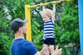 Little strong baby toddler with his father playing extreme sport