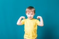 Little strong boy portrait showing muscles mischief
