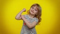 Little strong kid child girl showing biceps and feeling power strength, energy to gain success win