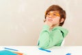 Little student boy studying and reading books. Cute schoolboy with eyeglasses doing homework Royalty Free Stock Photo