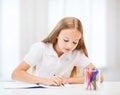 Little student girl drawing at school Royalty Free Stock Photo