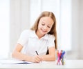 Little student girl drawing at school Royalty Free Stock Photo