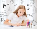 Little student girl drawing at school Royalty Free Stock Photo