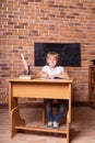 Little student girl sitting at a school desk and studying math. The child is doing homework. Preschool education Royalty Free Stock Photo