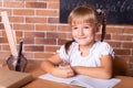 Little student girl sitting at a school desk and studying math. The child is doing homework. Preschool education Royalty Free Stock Photo