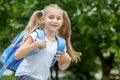 A little student is in a hurry to study with a backpack. The concept of school, study, education, friendship, childhood. Royalty Free Stock Photo