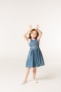 Little stylish child with arms up
