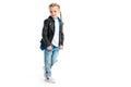 Little stylish kid wearing black leather jacket standing with fingers in pockets
