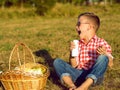 Little stylish kid wearing trendy checked shirt and jeans is hav