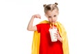 Little supergirl drinking milkshake and showing muscles