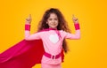 Little superhero girl pointing up Royalty Free Stock Photo