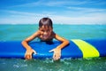 Little surfer board swim in sea hold surfboard Royalty Free Stock Photo