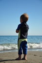 Little surfer boy on the beach Royalty Free Stock Photo