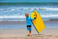 Little surfer run with bodyboard on sea beach Royalty Free Stock Photo