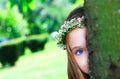 Little sweet girl hiding behind a tree Royalty Free Stock Photo