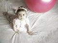 Little sweet girl plays with fitness ball on a white background. Healthy lifestyle. Gymnastics and baby sport Royalty Free Stock Photo