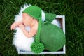 Little sweet newborn baby boy, sleeping in crate with wrap and h Royalty Free Stock Photo