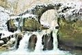 Mullerthal, Luxembourg - January 2024 - Schiessentumpel Waterfall under snow Royalty Free Stock Photo